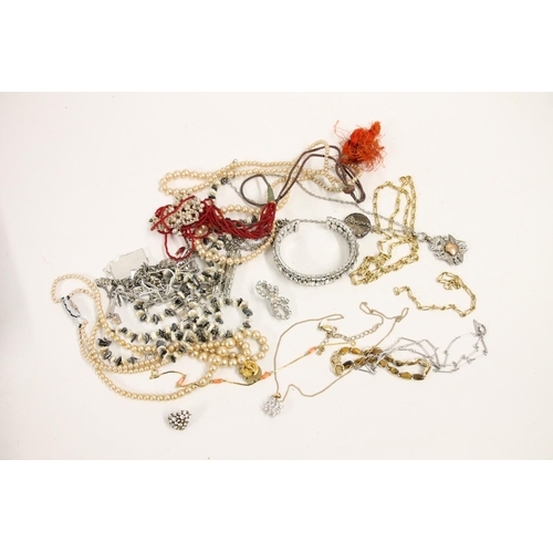 546 - Costume jewellery including a silver fob, silver locket, beaded necklaces etc.