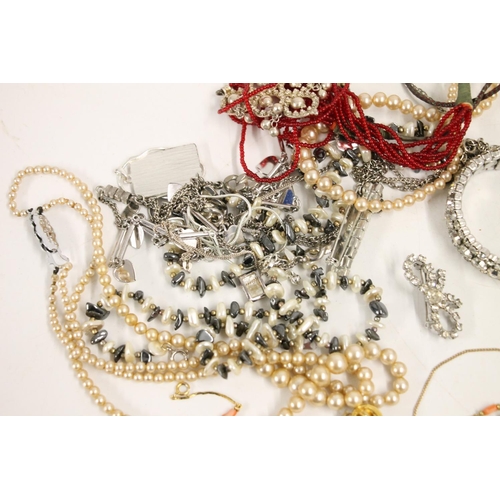 546 - Costume jewellery including a silver fob, silver locket, beaded necklaces etc.