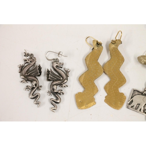 555 - Pair of silver dragon earrings together with other silver and costume earrings