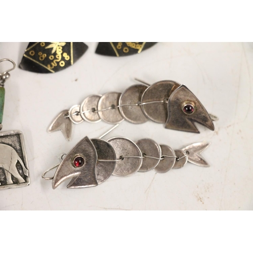 555 - Pair of silver dragon earrings together with other silver and costume earrings