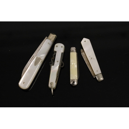 586 - Two hallmarked silver bladed and mother of pearl handled fruit knives, together with two non silver ... 