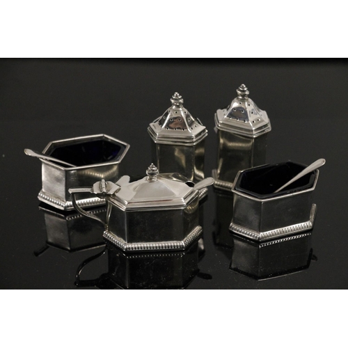 588 - George V Art Deco silver cruet set of geometric form with beaded foot, three with blue glass liners ... 