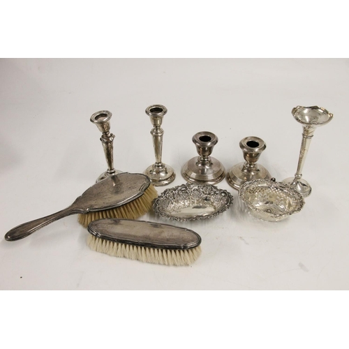 599 - Hallmarked silver items including two pairs of weighted candlesticks, two dressing table brushes, re... 