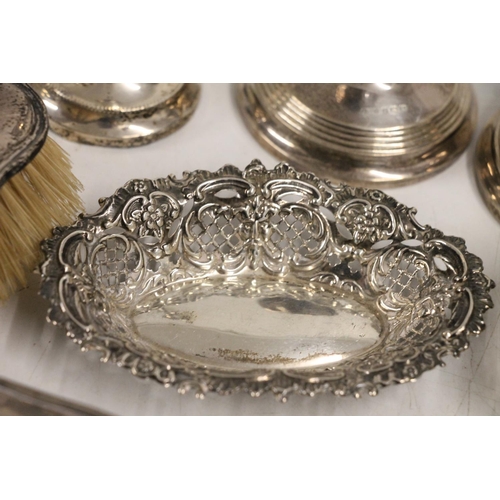 599 - Hallmarked silver items including two pairs of weighted candlesticks, two dressing table brushes, re... 