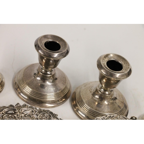 599 - Hallmarked silver items including two pairs of weighted candlesticks, two dressing table brushes, re... 