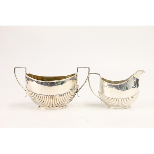 600 - Edward VII silver cream jug and matching sugar bowl, half fluted form with angular handles, Henry Wi... 