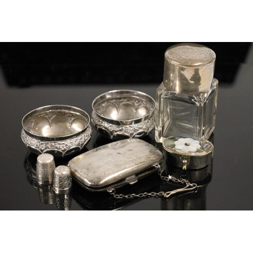 614 - Silver and glass table scent bottle, Mexican silver pill box, two thimbles, hallmarked silver case a... 