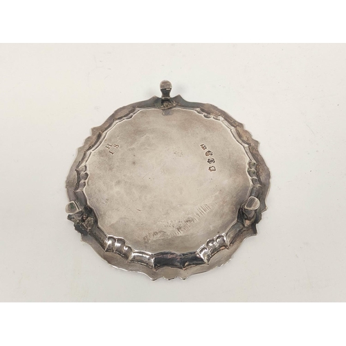 64 - Silver circular card tray with shaped moulded edge on pad feet, initialled by W Peaston 1749, 15.5cm... 