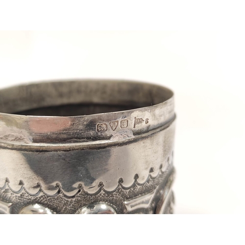 66 - Silver hemispherical bowl, embossed with scrolls, 1907 and a bottle holder. 222g. (2)