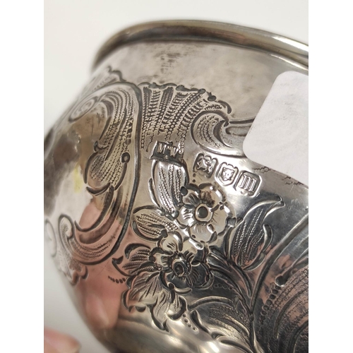 66 - Silver hemispherical bowl, embossed with scrolls, 1907 and a bottle holder. 222g. (2)