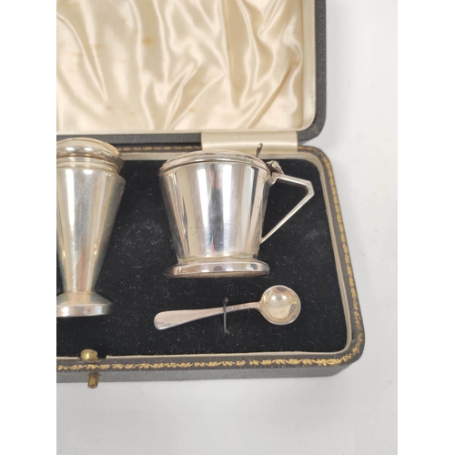 69 - Silver three piece condiment set of Art Deco plain, inverted conical shape, Birmingham 1939.