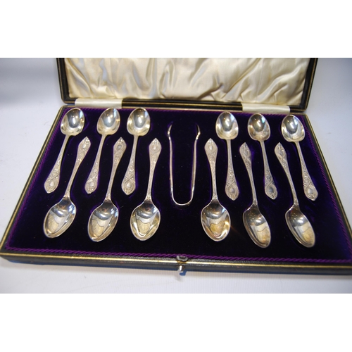 26 - Set of twelve embossed silver coffee spoons, with tongs, cased, 174g.