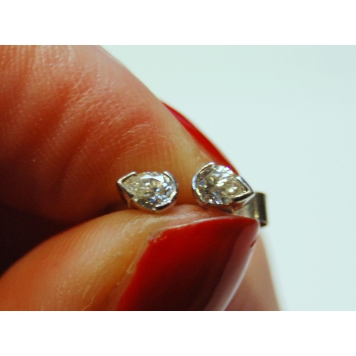 93 - Pair of diamond ear studs, each a pear-shaped brilliant, 18ct white gold, 5mm.