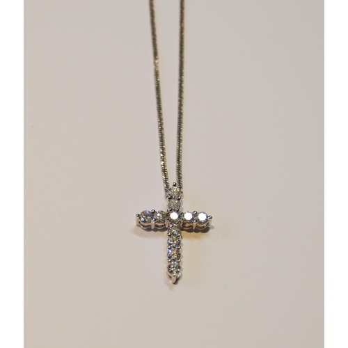 95 - Cross pendant with eleven diamond brilliants, in white gold (2.7g), platinum necklet, 5.8g in all.