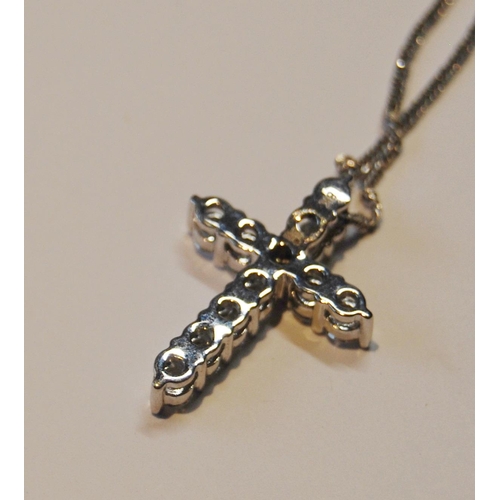 95 - Cross pendant with eleven diamond brilliants, in white gold (2.7g), platinum necklet, 5.8g in all.