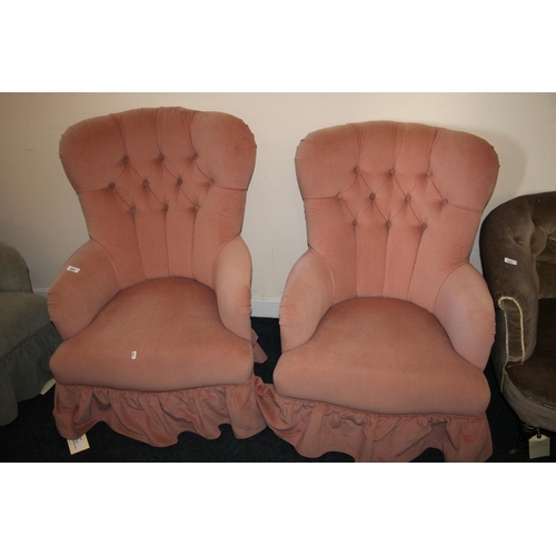 656 - Pair of pink deep button back upholstered armchairs.