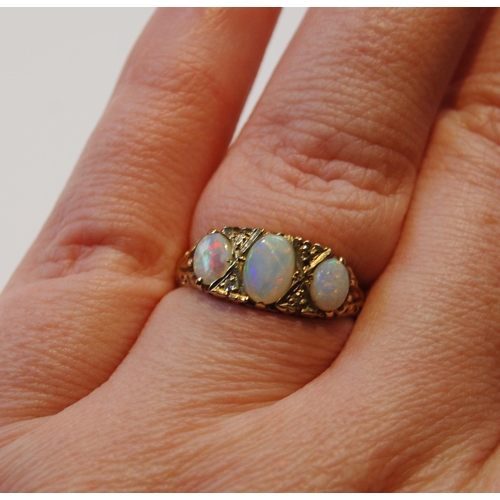 105 - Opal three-stone ring of Edwardian style with diamond chips, in 9ct gold, size N½, 4.3g gross... 