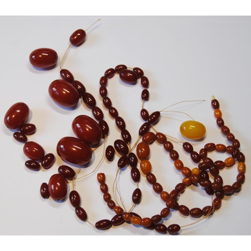 106 - Amber bead necklet of graduated variegated colours, partly un-strung, 84g.