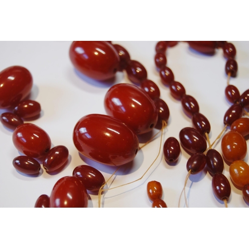 106 - Amber bead necklet of graduated variegated colours, partly un-strung, 84g.