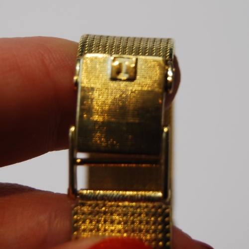 179 - Lady's Tissot 18ct gold watch with square dial, on integral Milanese bracelet, 41g including movemen... 