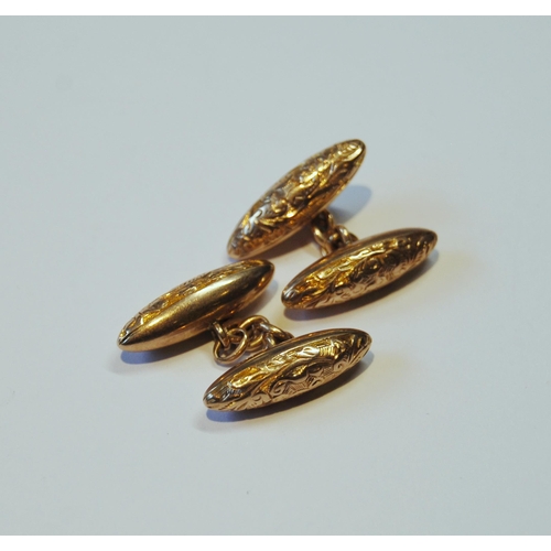 113 - Pair of gold engraved torpedo cufflinks, '10ct', 5g.