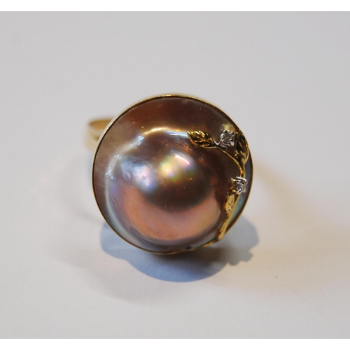 118 - Pair of mabe pearl ear clips and a similar ring with tiny diamonds, '14k'.