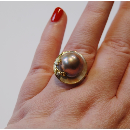 118 - Pair of mabe pearl ear clips and a similar ring with tiny diamonds, '14k'.