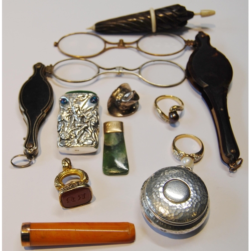 119 - Two lorgnettes, a gold-mounted amber cigarette holder, 1926, silver vesta, seal fob, greenstone pend... 