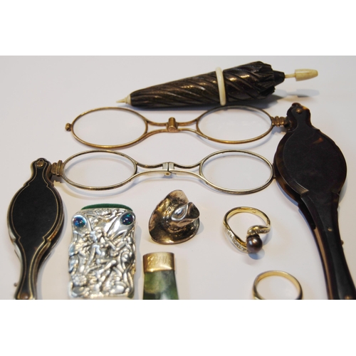 119 - Two lorgnettes, a gold-mounted amber cigarette holder, 1926, silver vesta, seal fob, greenstone pend... 