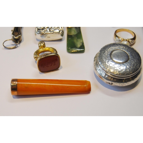 119 - Two lorgnettes, a gold-mounted amber cigarette holder, 1926, silver vesta, seal fob, greenstone pend... 