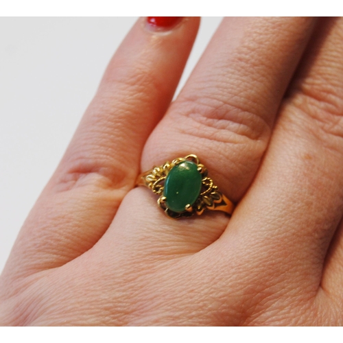 141 - Jadeite ring in gold, probably '18', size O.