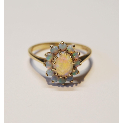 143 - Opal oval cluster ring, in 9ct gold, size O.