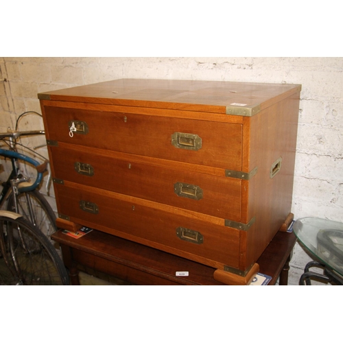 619 - 20th century teak campaign style chest, with brass bound corners and recessed handles, raised on bra... 