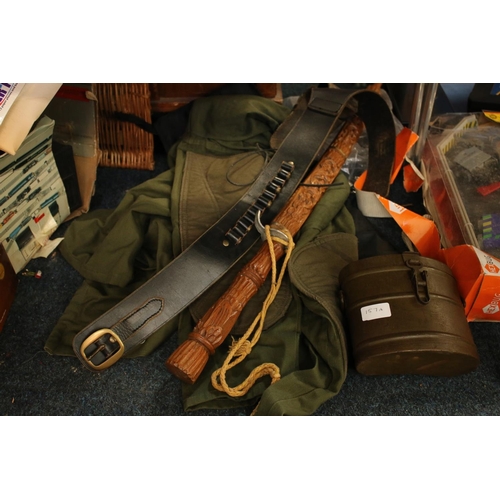 157A - Black leather belt with holster, an Indian sword, a canister holder, an army jacket and a gun case.