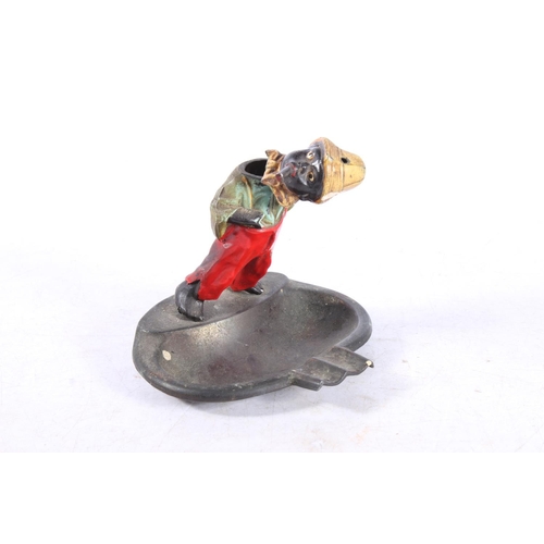 194 - Novelty cold painted metal ashtray with boy smoking surmount, 11cm high.