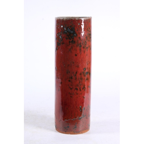 276 - Studio pottery vase of cylindrical form decorated with heavy red drip glaze. Indistinctly signed to ... 