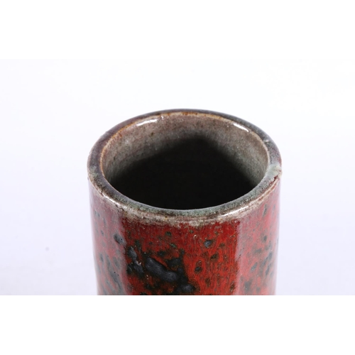 276 - Studio pottery vase of cylindrical form decorated with heavy red drip glaze. Indistinctly signed to ... 