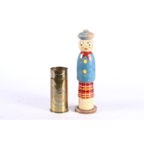 285 - Early 20th century painted treen figure/spill holder in the form of a Scotsman in traditional attire... 