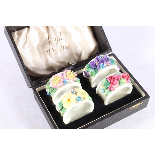 287 - Four cased Royal Doulton floral encrusted napkin rings.