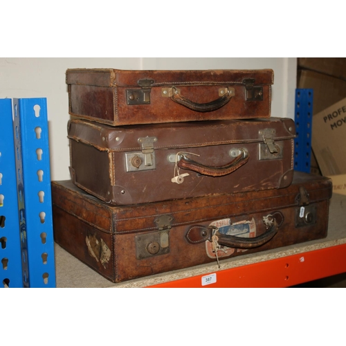 387 - Three leather bound antique cases.