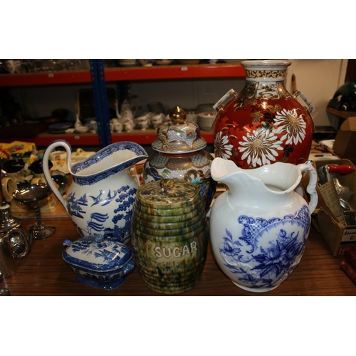 427 - Large oriental inspired vase, a blue and white water jug, an oriental ginger jar and cover, etc.