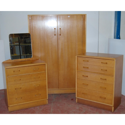 438 - Ernest Gomme for G Plan 1960s light oak three-piece bedroom suite comprising a two-door wardrobe, ch... 