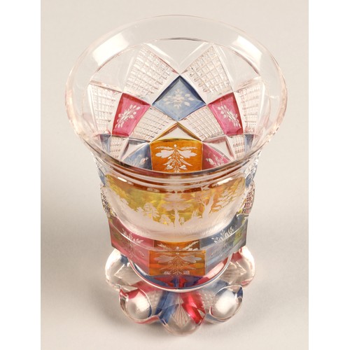 227 - Bohemian glass beaker with engraved hunting scene, clear with pink,blue and amber flashed decoration... 