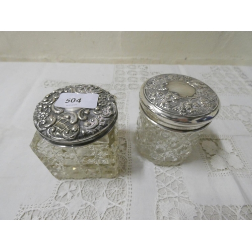 504 - Two cut glass silver topped dressing table jars.