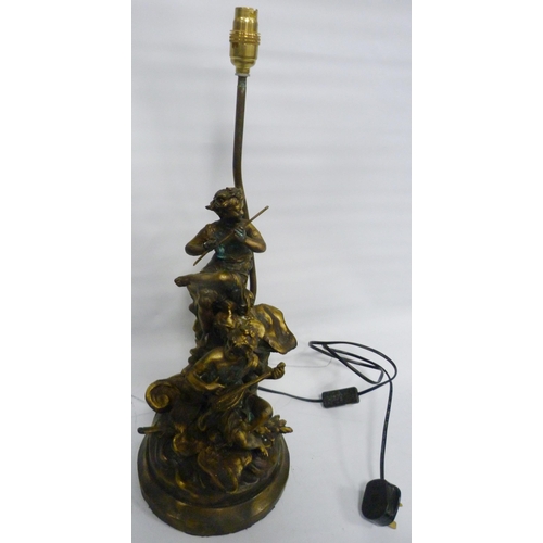 304 - After the OriginalBronzed metal figural table lamp in the form of classical musical figures playing ... 