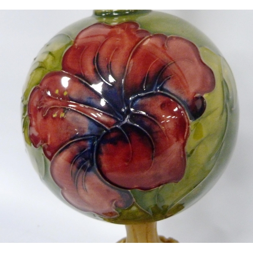 220 - Moorcroft 'Hibiscus' table lamp with spherical tube-lined column on green ground, 41cm high.