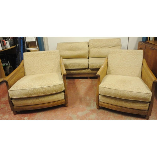 447 - Ercol teak and bergère three-piece suite comprising a large settee and a pair of armchairs, fabric-c... 