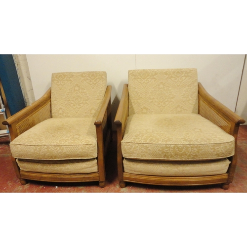 447 - Ercol teak and bergère three-piece suite comprising a large settee and a pair of armchairs, fabric-c... 