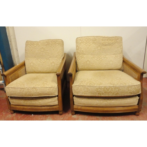 447 - Ercol teak and bergère three-piece suite comprising a large settee and a pair of armchairs, fabric-c... 