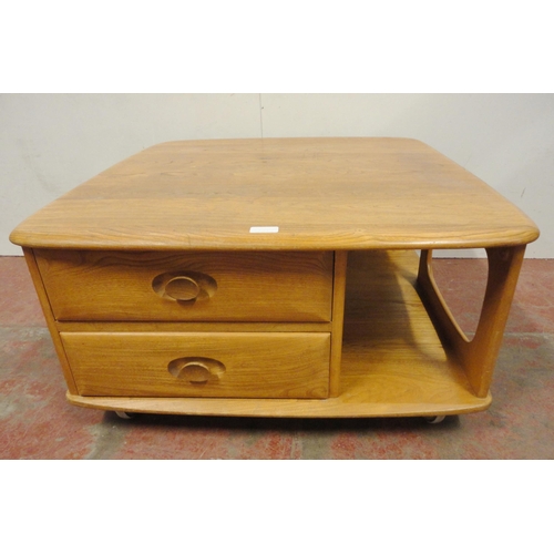 449 - Ercol blonde elm Pandora's Box coffee table of square form with two drawers to one end, flanked by o... 